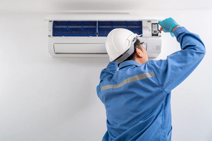 Air Con Technician Brisbane technician fixing air con for air conditioning business in Brisbane